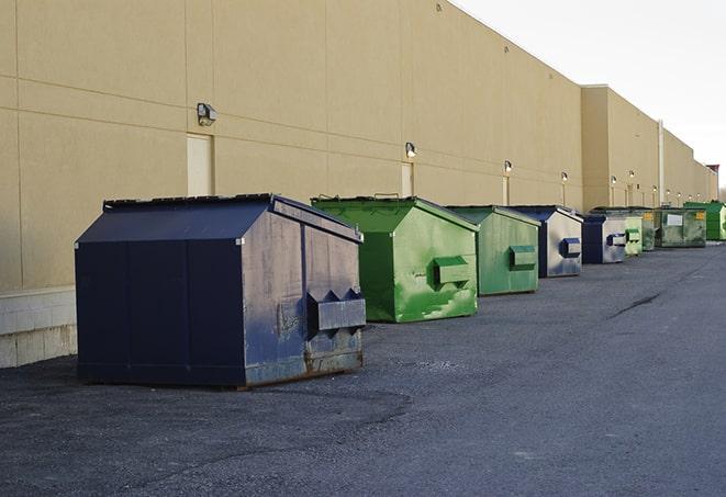 a group of construction workers taking a break near a dumpster in Garden City MI